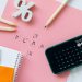 Flat lay showing tax planning tools including a calculator, pencils, and stationery items.